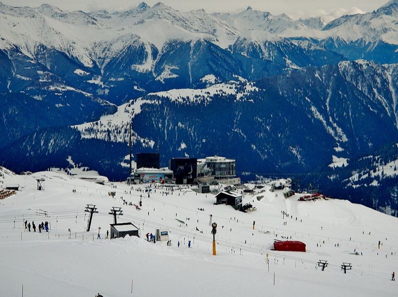 Ski runs, lifts and skiers spread below the Crap Sogn Gion ridge