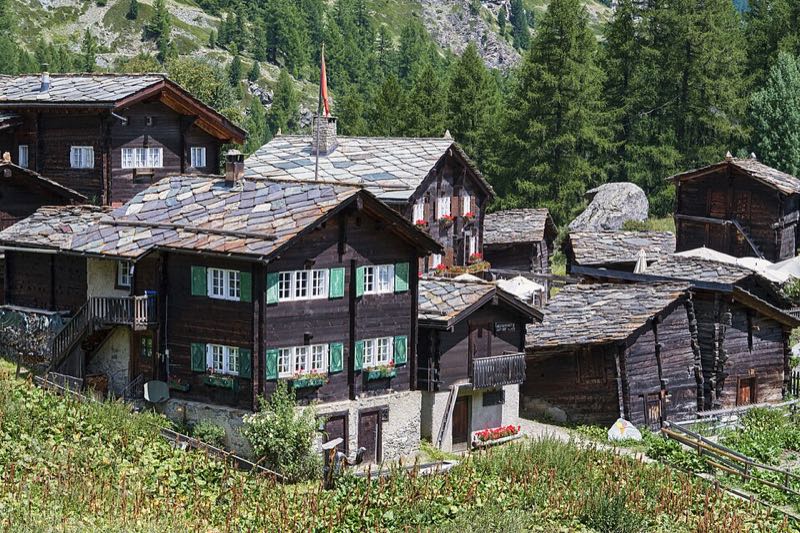 Traditional Valais timber chalets with stone-slab roofs in a hamlet above Zermatt