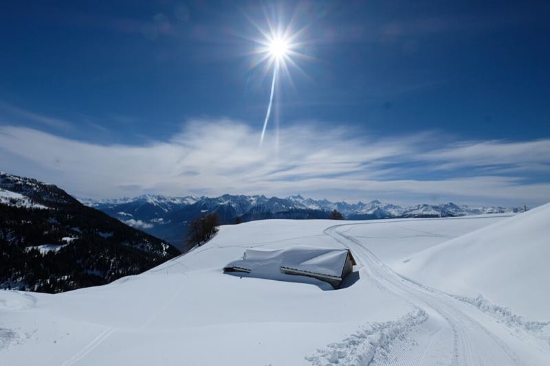 Deep snow on the open slopes above Crans-Montana looking across to the Valais Alps