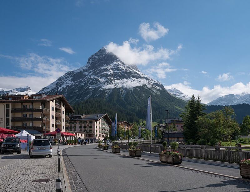 The snow-capped Omeshorn peak towering over the main street and chalet hotels of Lech village
