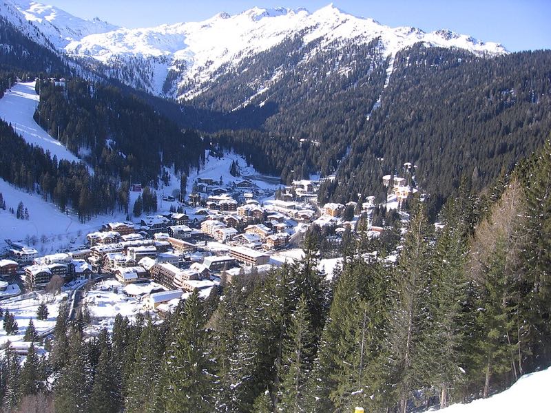 Madonna di Campiglio under winter snow, with pistes dropping into the village