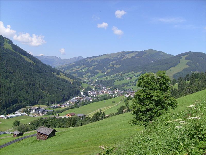 Saalbach village nestled in its green valley with ski slopes on the surrounding mountains