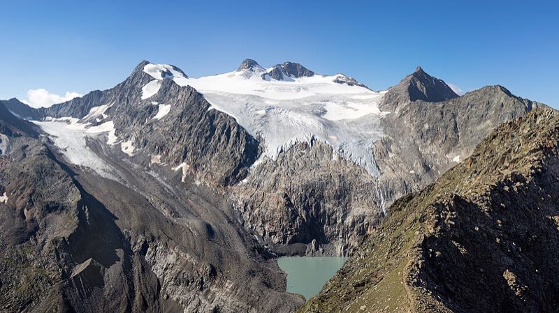 The Sulzenauferner glacier and surrounding high peaks above a turquoise glacial lake in the Stubai Alps