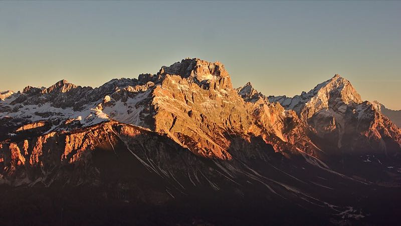 Sunset alpenglow lighting the jagged Dolomite peaks of Sorapiss and Antelao above Cortina d Ampezzo