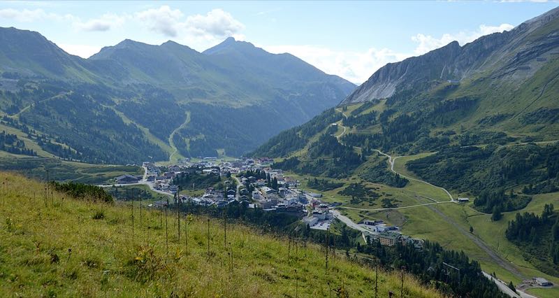 View of Obertauern village and mountains from the Grünwaldsee lake