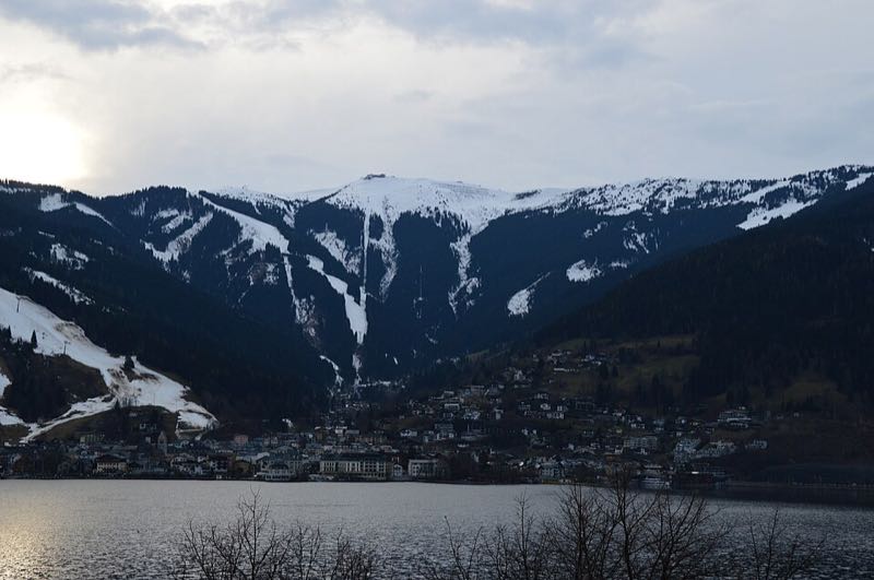 Zell am See across the lake with the snowy Schmittenhöhe ski slopes rising behind the town